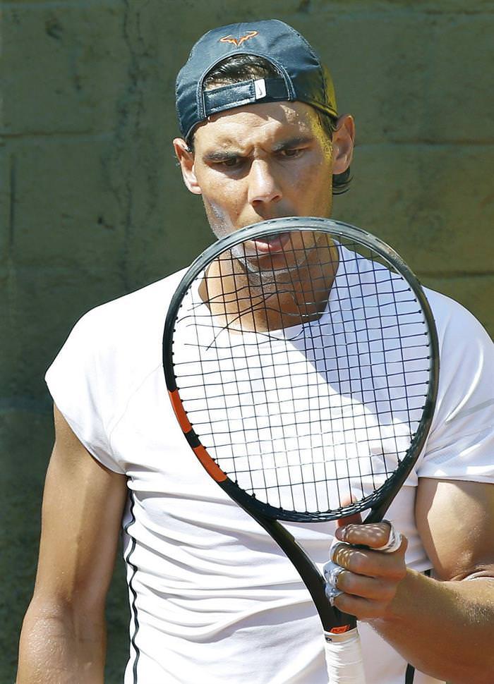 Rafael Nadal breaking a string during practice